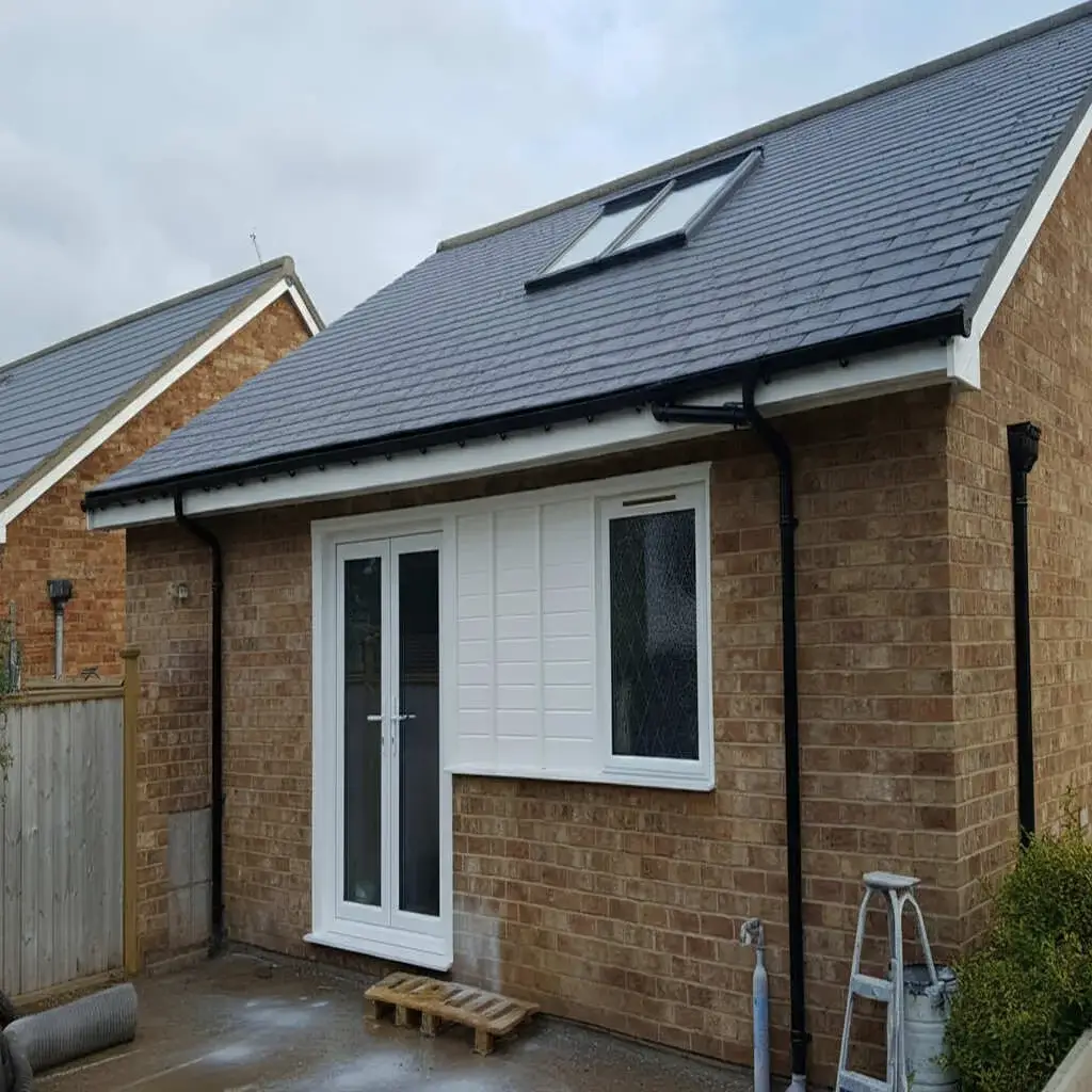 Fascia Gutter spray painting on a modern UK home with clean white finish and restored exterior